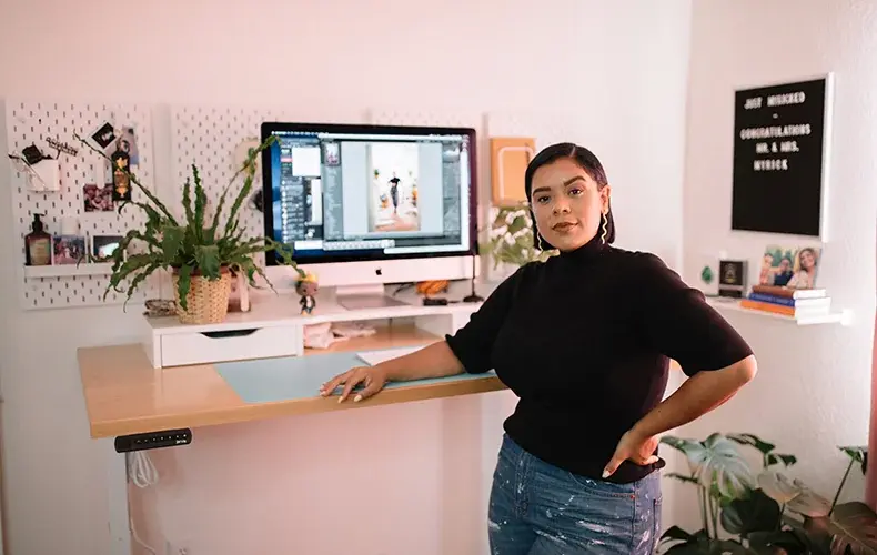 Entrepreneur Denisse Myrick standing in her home office.