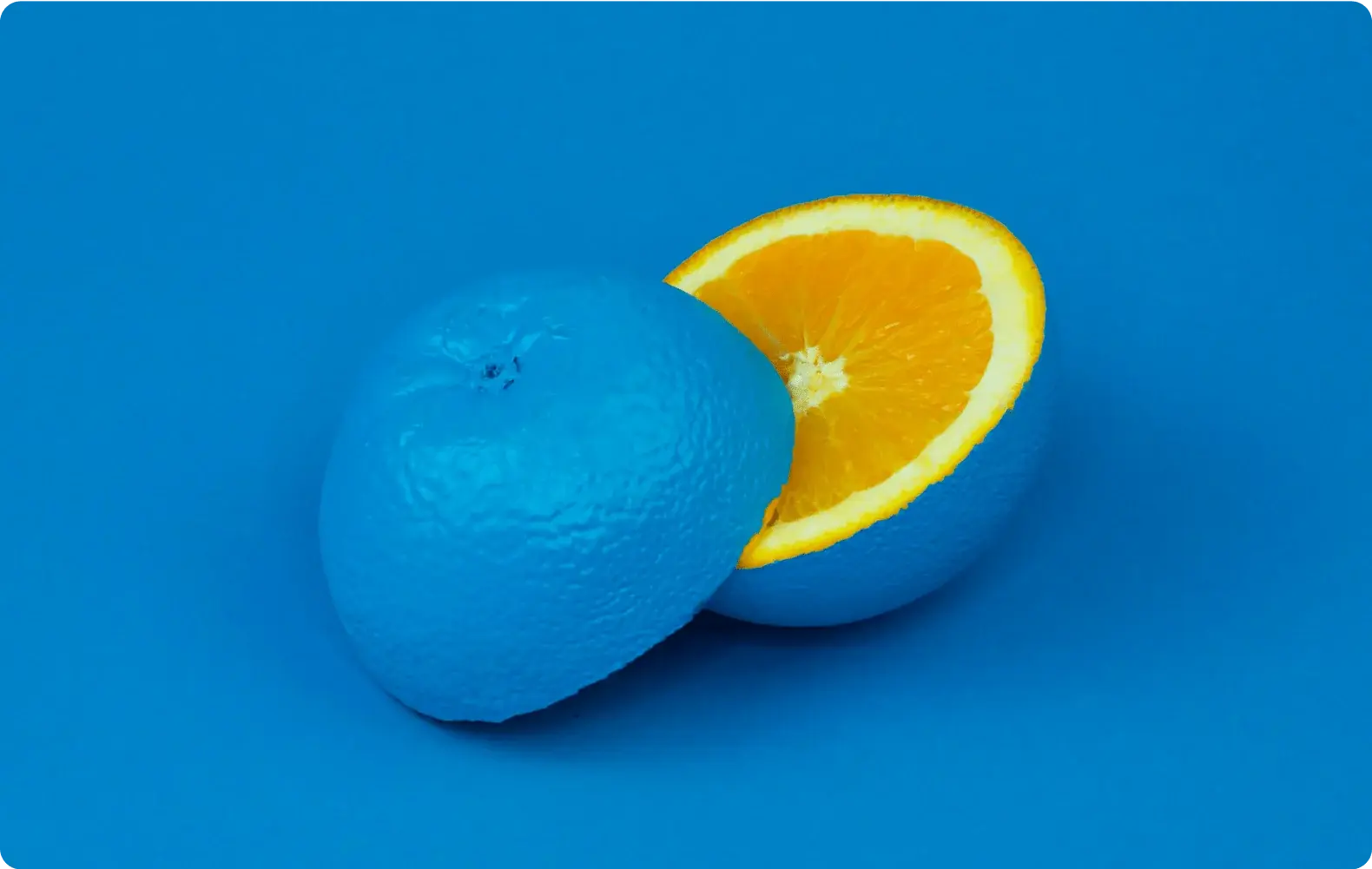 Image of an orange with an unexpected blue exterior to indicate standing out.