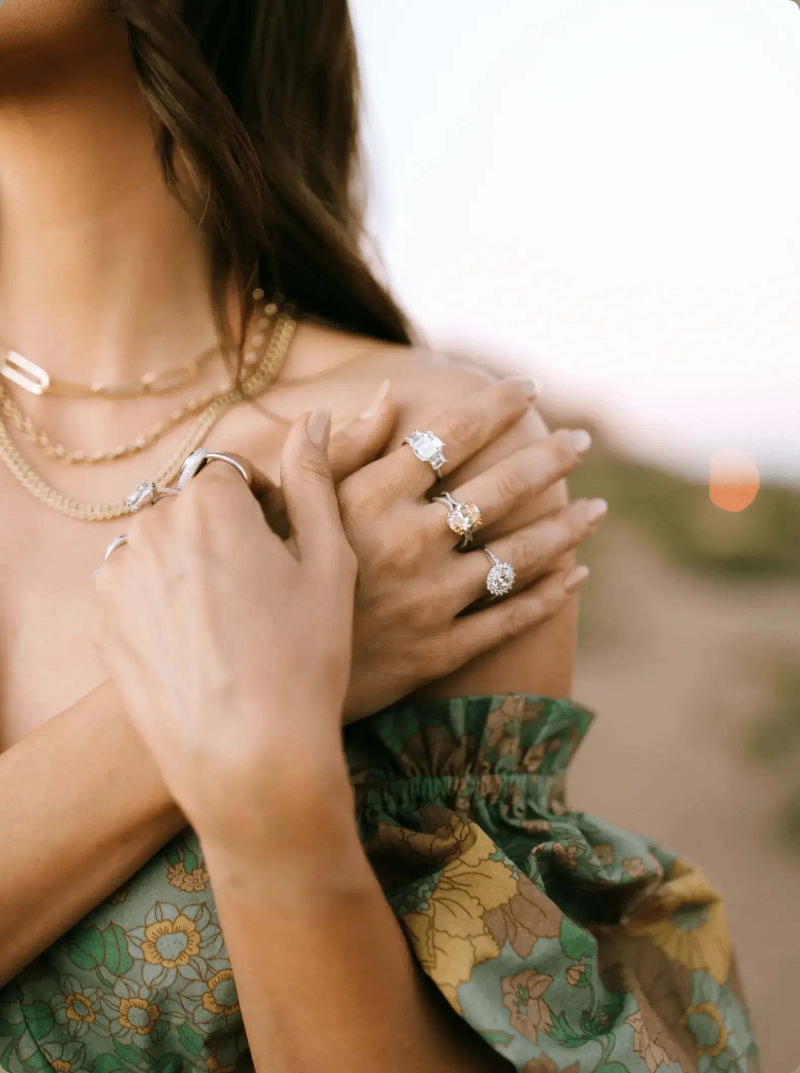 Photograph of a woman modeling jewelry.