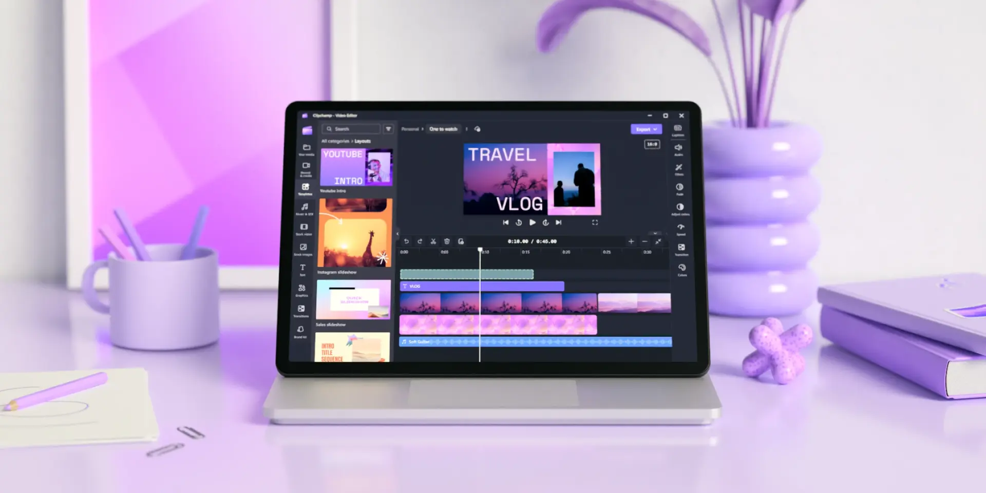 A purple-themed desk with video editing tool Clipchamp open on a laptop.